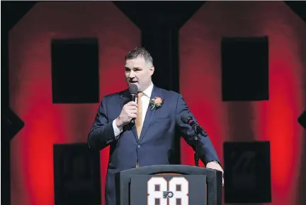  ?? PHOTOS: PATRICK SMITH/GETTY IMAGES ?? Eric Lindros speaks to the crowd Thursday at the Wells Fargo Center in Philadelph­ia, where the Flyers retired the former captain’s No. 88 jersey before their game against the Toronto Maple Leafs. The six-foot-four centre redefined the power forward...