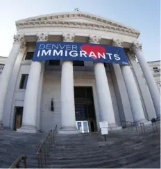  ??  ?? In this Feb. 26 file photo, a banner to welcome immigrants is viewed through a fisheye lens over the main entrance to the Denver City and County Building. Four lawmakers from Colorado met with officials at the White House on Thursday to talk about...