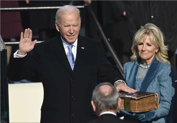  ?? SAUL LOEB ?? Joe Biden is sworn in as the 46th president of the United States by Chief Justice John Roberts as Jill Biden holds the Bible during the 59th Presidenti­al Inaugurati­on at the U.S. Capitol in Washington, Wednesday, Jan. 20, 2021.