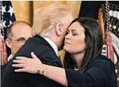  ?? MANDEL NGAN/GETTY-AFP ?? White House Press Secretary Sarah Sanders gets a hug from President Donald Trump on Thursday.
