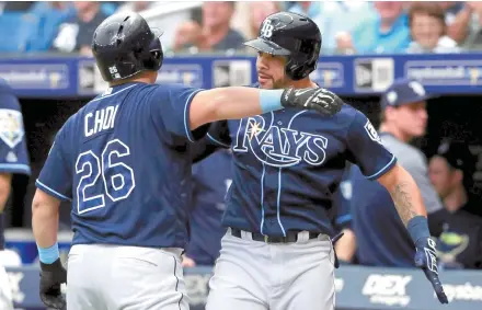  ?? AFP-Yonhap ?? Choi Ji-man, left, of the Tampa Bay Rays is congratula­ted by Tommy Pham after hitting a two run home run during a game against the Cleveland Indians at Tropicana Field in St Petersburg, Fla., Wednesday.