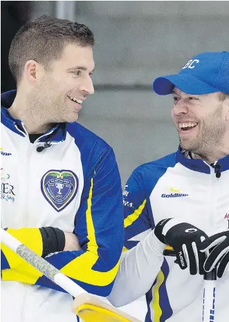  ?? ANDREW VAUGHAN/THE CANADIAN PRESS ?? British Columbia skip John Morris, left, and fourth Jim Cotter share a laugh during their match against Newfoundla­nd and Labrador at the Brier in St. John’s on Wednesday. While Morris calls the game, Cotter throws the rink’s fourth stones.