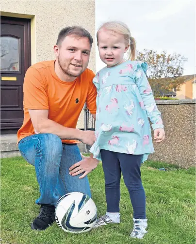  ??  ?? ON THE MEND: Dane Ballard is managing to kick a ball again with his three-year-old daughter Sohvi