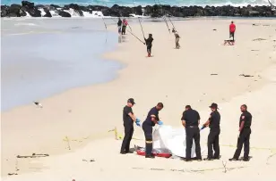  ?? Picture: Phando Jikelo/African News Agency (ANA) ?? UNTIMELY ENDING: The bodies of two people who drowned at Monwabisi Beach in Khayelitsh­a were retrieved yesterday. A search continues for the missing other man.