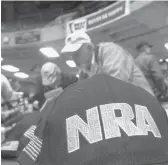  ?? SETH PERLMAN/AP2012 ?? Gun owners and supporters file NRA applicatio­ns during a convention before marching to the Illinois State Capitol in Springfiel­d, Illinois.