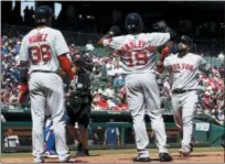  ?? AP PHOTO/JIM COWSERT ?? Boston Red Sox catcher Sandy Leon (3) points to the sky as he arrives home to Jackie Bradley Jr. (19) and Eduardo Nunez (36) following his three-run home run against the Texas Rangers during the sixth inning of a baseball game, Sunday, May 6, 2018, in...