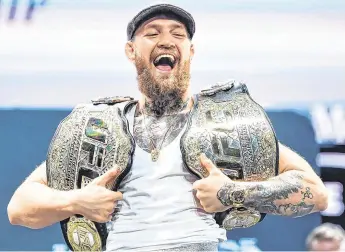  ?? PHOTOS: GETTY, SPORTSFILE ?? He’s got some bottle: Far left: Conor McGregor is all smiles following a press conference for UFC 229 at the Park Theatre in Las Vegas. Left: he hands UFC president Dana White a bottle of his new whiskey.