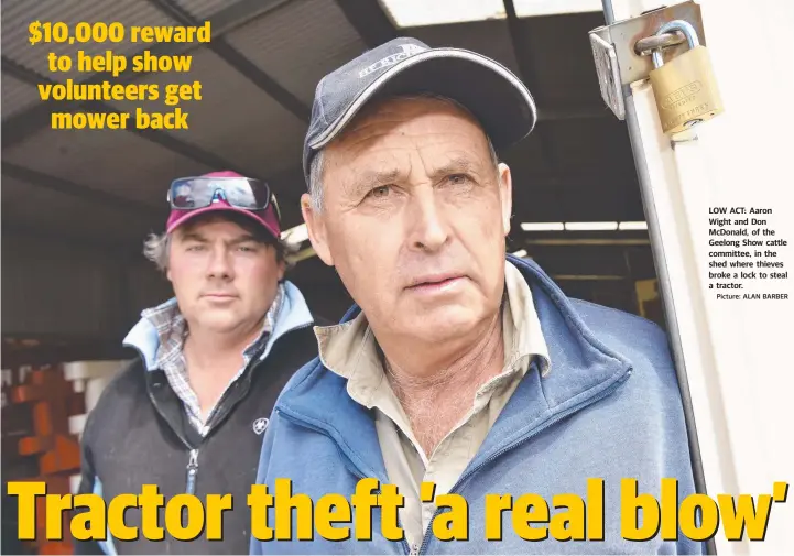  ?? Picture: ALAN BARBER ?? LOW ACT: Aaron Wight and Don McDonald, of the Geelong Show cattle committee, in the shed where thieves broke a lock to steal a tractor.