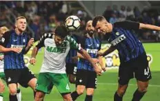  ?? AFP ?? Inter Milan’s Croatian forward Ivan Perisic heads the ball during the Italian Serie A match against Sassuolo at the San Siro stadium in Milan on May 12.