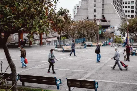  ?? Jessica Christian/The Chronicle ?? People walk through Portsmouth Square in 2021. The city park in Chinatown is about to undergo a $60 million renovation, which will begin late this year and last 24 months. The park will be closed while the work is done.