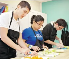  ?? BRIGHTTON SCHOOL PHOTOGRAPH ?? Students in the family studies program at Brighton learn important life skills including cooking, food safety, nutrition and the economics of running a household.