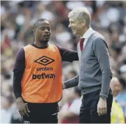  ??  ?? 2 Arsenal manager Arsene Wenger chats with compatriot Patrice Evra, a substitute for West Ham yesterday.