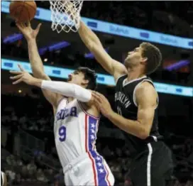  ?? CHRIS SZAGOLA — THE ASSOCIATED PRESS ?? Dario Saric, left, being defended by Brooklyn’s Brook Lopez, has been put on a restricted playing schedule by the 76ers’ medical staff for the remainder of the season.