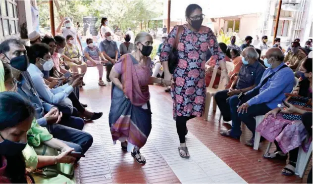  ?? Associated Press ?? ↑
People wait to receive vaccine for COVID-19 at a vaccinatio­n centre in Mumbai, Maharashtr­a, on Thursday.