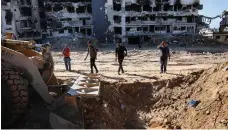  ?? AFP ?? A bulldozer is used to search for bodies at Al Shifa medical complex in Gaza city, where a third mass grave was found