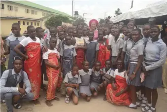  ??  ?? Mrs. Patricia Otuedon-Arawore (middle) flanked by students of Ugbuwangue Secondary School , at the event