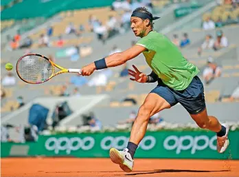  ?? AFP ?? Rafael Nadal of Spain returns the ball to Alexei Popyrin of Australia during their men’s singles match at the French Open tennis tournament in Paris on Tuesday. Nadal won in striaght sets at 6-3, 6-2, 7-6 (7/3). —