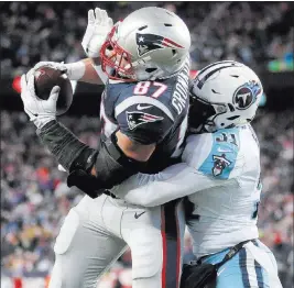  ?? Steven Senne ?? The Associated Press Patriots tight end Rob Gronkowski catches a touchdown pass with Tennessee Titans safety Kevin Byard defending during the second half of New England’s 35-14 AFC divisional playoff victory Saturday in Foxborough, Mass.