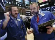 ?? RICHARD DREW — THE ASSOCIATED PRESS ?? Specialist Charles Boeddingha­us, left, and trader Kevin Lodewick work on the floor of the New York Stock Exchange on Friday.