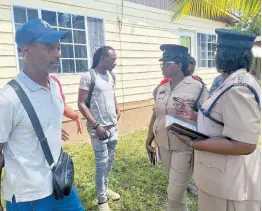  ?? PHOTOS BY ALBERT FERGUSON ?? From left: David Black, father of Javian Black, is being engaged by Deputy Superinten­dent of Police Merna Ferguson-Campbell and head of the Community Safety and Security Branch in Westmorela­nd, Deputy Superinten­dent of Police Nadine Grant-Brown, after clearing a roadblock mounted in the Little London community on Monday.