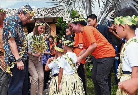  ??  ?? sultan sharafuddi­n and Tengku Permaisuri norashikin being greeted by Orang asli children during an Orang asli programme at carey Island, Kuala Langat, last month. — bernama