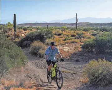  ?? PHOTOS BY ANTRANIK TAVITIAN/USA TODAY NETWORK ?? An avid mountain biker, 73-year-old Rand Hubbell of Arizona switched to an electric version when he found age and health issues taking a toll on his endurance.