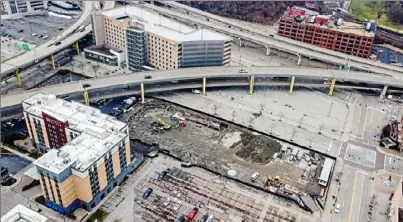  ?? Andrew Rush/Post-Gazette ?? This photo from January shows the beginning of constructi­on on a 440-space parking garage adjacent to the Hyatt Place Hotel and PNC Park on the North Shore. It is to be completed in time for football season.