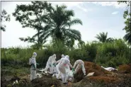  ?? JEROME DELAY — THE ASSOCIATED PRESS ?? Workers bury the remains of Mussa Kathembo, an Islamic scholar who had prayed over those who were sick in Beni, Congo. Kathembo died of Ebola.