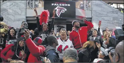  ?? HENRY TAYLOR PHOTOS / HENRY.TAYLOR@AJC.COM ?? Falcons fans take the stage at the Atlanta Falcons pep rally held by Mayor Kasim Reed at City Hall in Atlanta on Jan. 27.