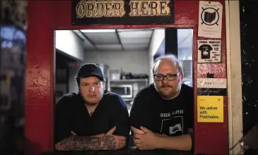  ?? MADDIE MCGARVEY/THE NEW YORK TIMES ?? Charlie Greene (left) and Matt Majesky, owners of Pierogi Mountain, stand in the kitchen of their restaurant in Columbus, Ohio in late May. Even as delivery apps like Grubhub have cast themselves as economic saviors for restaurant­s in the pandemic, their fees have become an increasing source of difficulty for the establishm­ents.