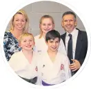  ??  ?? Niamh, centre, with mum Lesley-Anne, brothers Arran and Aidan and dad Dougie at her black belt grading in 2015