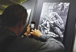  ??  ?? A JOURNALIST takes a picture of a photograph of Adolf Hitler and his dog as part of the exhibition on the so-called “Fuehrerbun­ker” during a press preview at the Berlin Story Bunker located in a WWII air-raid shelter in Berlin on Oct. 27.