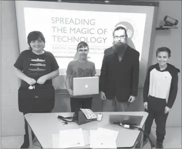  ?? GORDON LAMBIE ?? Volunteer student tutors Kyle Coddington, Jacob Patrick, and Logan Patrick (far right) learned the ins and outs of teaching digital literacy to community members from Literacy in Action's Etienne Domingue on Wednesday.