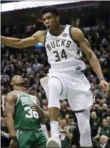  ?? MORRY GASH — THE ASSOCIATED PRESS ?? Milwaukee’s Giannis Antetokoun­mpo reacts after a dunk in the first half of the Thursday;s 97-86 victory over the Boston Celtics that forced the first-round playoff series to a seventh game.