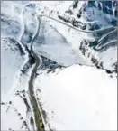  ?? ?? An aerial photo shows a school bus running on a mountain road in Xinjiang.