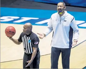  ?? AP ?? 15A
Michigan head coach Juwan Howard questions a call during the second half of a firstround game against Texas Southern in the NCAA Tournament on Saturday at Mackey Arena in West Lafayette, Ind.