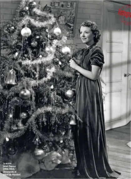  ??  ?? La actrizJane­t Gaynor (1906-1984), decorando el árbol de Navidad.