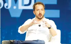  ??  ?? Drew Houston, Chief Executive Officer and founder of Dropbox, stands in front of the company’s logo at an announceme­nt event in San Francisco, California. — Reuters photo