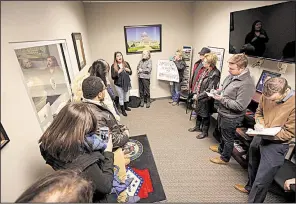  ?? Arkansas Democrat-Gazette/STATON BREIDENTHA­L ?? Diana Pacheco (top, left) speaks out Thursday in U.S. Sen. Tom Cotton’s Little Rock office as other demonstrat­ors line a wall and Cotton staff members take notes.