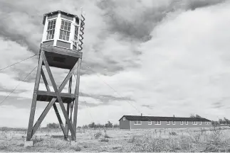  ?? Helen H. Richardson, Denver Post file ?? A replica of a guard tower can be seen at Camp Amache in 2016. A renovated building that was once living quarters can be seen in the back. More than 7,000 people of Japanese descent were interned there during World War II.