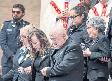  ?? ANDREW FRANCIS WALLACE/TORONTO STAR ?? The parents of Anne Marie D'Amico, one of 10 people killed in the April 23 van rampage on Yonge St., leave their daughter's funeral at St. Clare’s Roman Catholic Church on Wednesday.