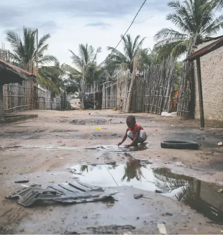  ?? ALFREDO ZUNIGA / AFP VIA GETTY IMAGES ?? A child plays in one of the alleys of the port of Paquiteque­te near Pemba in Mozambique. Sailing boats are expected to arrive with people displaced from the coasts of Palma and Afungi after suffering deadly attacks by militants.