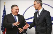  ?? FRANCISCO SECO / AP ?? Secretary of State Mike Pompeo (left) shakes hands with NATO Secretary General Jens Stoltenber­g prior to a meeting in Brussels on Tuesday.