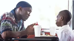  ?? A24 FILMS / ASSOCIATED PRESS ?? Mahershala Ali (left) and Alex Hibbert converse in “Moonlight,” which won Best Picture at the 2016 Academy Awards. That was the only film among 2016’s top 100 to feature a gay protagonis­t, according to an annual study done by the University of Southern...