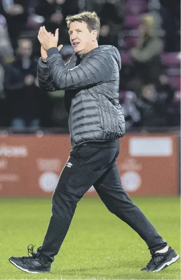  ??  ?? 0 Hearts manager Daniel Stendel applauds the fans after the game against Aberdeen at Tynecastle.