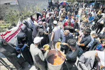  ?? Ashraf Amra Anadolu ?? PEOPLE displaced from Rafah in Gaza by Israeli military operations wait Monday for food from charity organizati­ons in Deir al Balah. Almost all of the Gaza Strip relies on such groups’ distributi­on of food to survive.