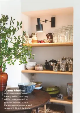 ??  ?? Front kitchen Well-lit shelving makes it easy to find crockery, while cutlery stored in glasses frees up space. Farmhouse-style cone wall
sconce 1, Litfad, is similar