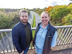  ?? ?? Cllrs Sam and Elizabeth Bromiley, who represent the Parkwall and Warmley Ward on South Gloucester­shire Council, on the A4174 Avon Ring Road where a ‘noise camera’ is being trialled