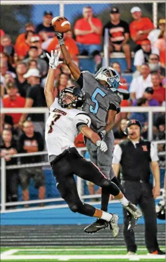  ?? TIM PHILLIS - THE NEWS-HERALD ?? South receiver Rico Small leaps to make a one-handed catch over North’s Kenny Streb on Sept. 22.