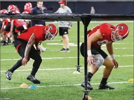  ?? CURTIS COMPTON / CCOMPTON@AJC.COM ?? UGA tailback D’Andre Swift (left) and tight end Charlie Woerner run a drill at Saturday’s practice for Wednesday’s Sugar Bowl in New Orleans.